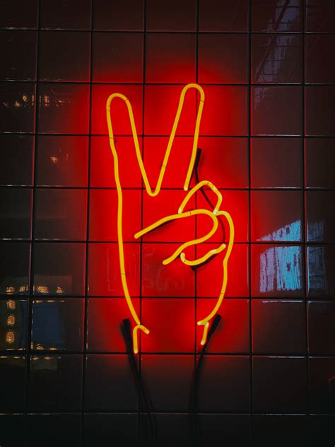 Download Neon Peace Signage In Red Wallpaper