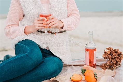 Woman With Glass Of Rose Wine Is Sitting On The Beach Having Autumn