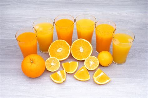 Free Photo Glass Of Orange And Lemon Juice On White Table