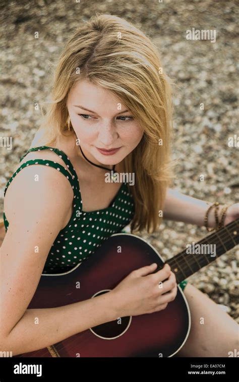 Young Woman Playing Guitar High Angle Stock Photo Alamy