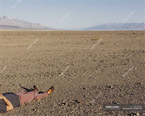 Cropped View Of Man Lying On Ground In Desert Of Death Valley National