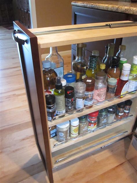 An Open Cabinet Filled With Spices And Condiments On A Wooden Floor In