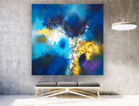 An Abstract Painting Hangs On The Wall Above A Couch