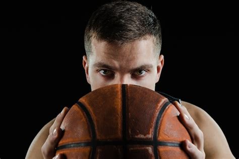 Free Photo Basketball Player Covering His Face With A Ball