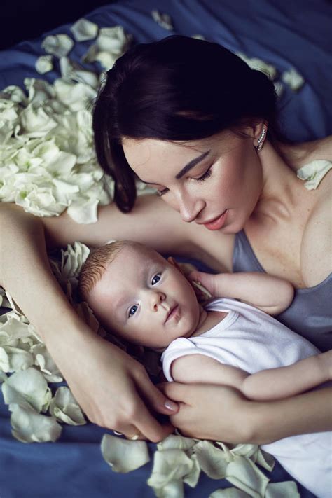 Mom Brunette With A Newborn Boy Lies On The Bed With White Rose Petals Photograph By Elena