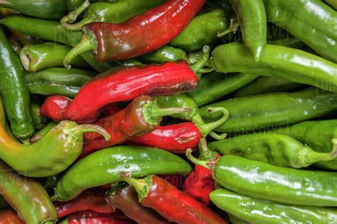 Red And Green Jalapeno Peppers On Display In A Market Stock Photo