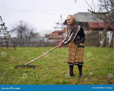 Old Farmer Woman Cleaning With A Rake Stock Image Image Of Europe