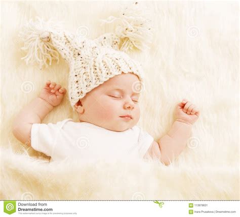 Baby Sleep Newborn Kid In Woolen Hat Sleeping On White Blanket Stock