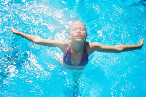 girl jumping for joy in blue sunshine pool by stocksy contributor wendy laurel stocksy