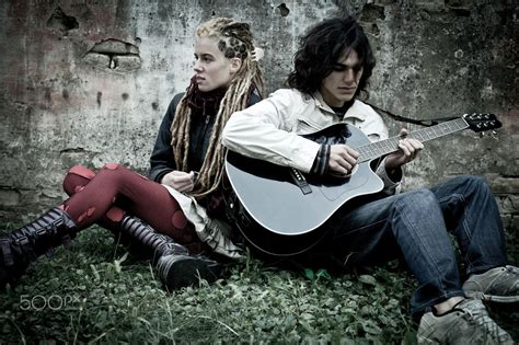Cool teenage couple - Trendy teenage couple sitting next grunge wall. | Teenage couples ...