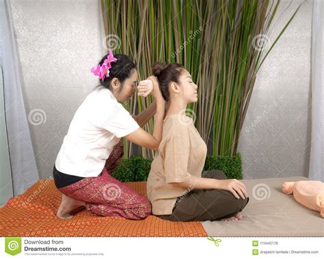 Professional Therapist Giving Traditional Thai Massage To A Woman In Spa Center Healthy Concept