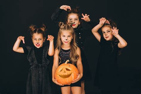 Free Photo Group Of Girls Dressed In Halloween Costumes In Studio