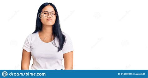 Young Beautiful Asian Girl Wearing Casual Clothes And Glasses Looking