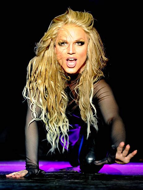 A Woman With Long Blonde Hair Posing For The Camera