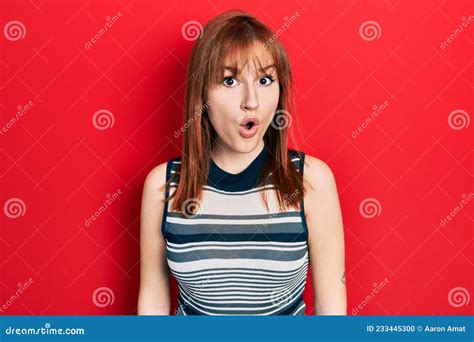 Redhead Young Woman Wearing Casual T Shirt Afraid And Shocked With