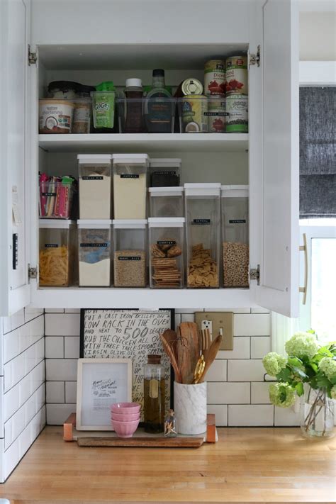 Mount a wall file or magazine holder to your cabinet door to hold plastic lids. Small Space Living Series- Kitchen Cabinets and Organizing Tips - Nesting With Grace