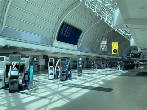 Interior Of Modern Airport With Departure Board And Automatic Terminals