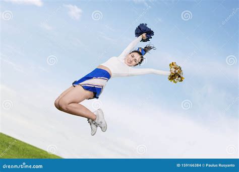 Pretty Cheerleader Girl Jumping With Pom Poms Stock Photo Image Of