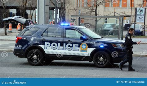 Two Montreal Police Service Spvm Cars Standing In Front Of A Local