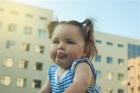 Portrait Of A Joyful Young Child Outdoors Baby Girl On Urban Landscape