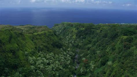 Aerials Of Lush Green Mountains Leading Into Ocean Filmpac