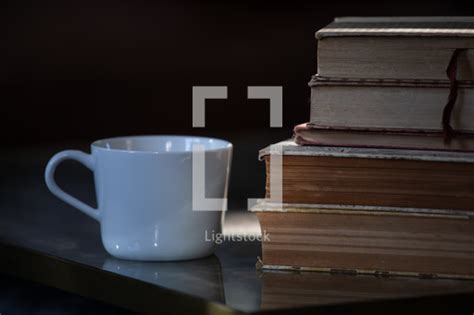 Coffee Cup And A Stack Of Old Books On A Table — Photo — Lightstock