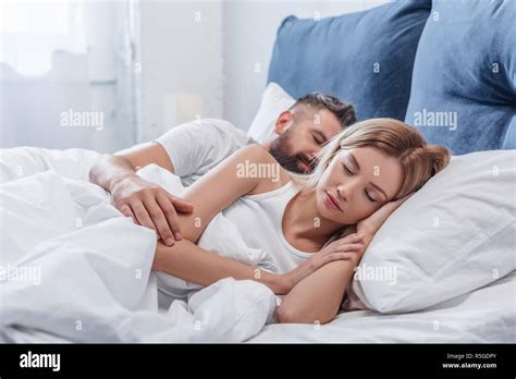 Beautiful Blonde Woman Sleeping In Bed With Boyfriend In Morning Stock
