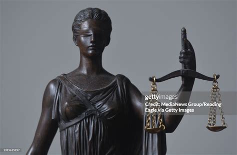 A Detail Photo Of A Statue Of The Blindfolded Lady Justice Holding