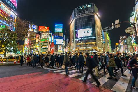 Crowds Of People Walking Across At Shibuya Famous Crossing Street At