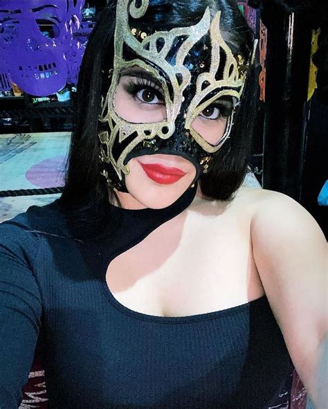 A Woman With Black Hair Wearing A Mask