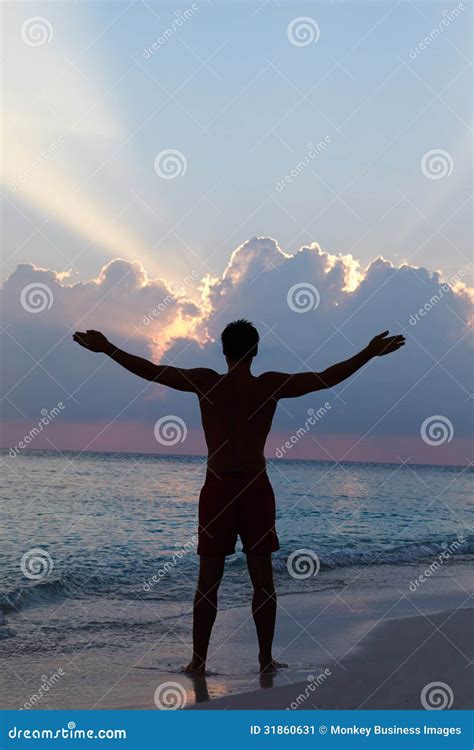 Silhouette Of Man With Outstretched Arms On Beach Royalty Free Stock