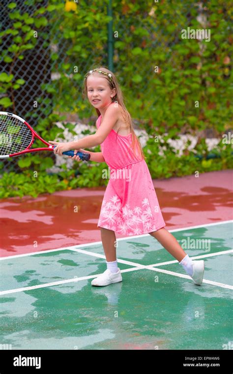 Little Girl Playing Tennis On The Court Stock Photo Alamy