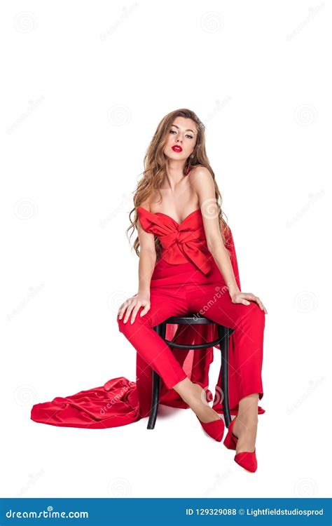 Beautiful Seductive Woman Posing In Red Clothes On Chair Stock Photo