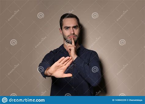 Man Showing Hush Gesture In Sign Language On Background Stock Image