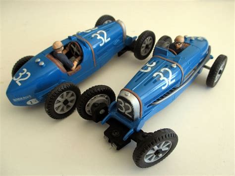 Two Blue Toy Cars Sitting On Top Of A White Table