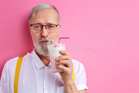 Portrait Of Funny Caucasian Mature Man Holding Milk Cocktail In Hands