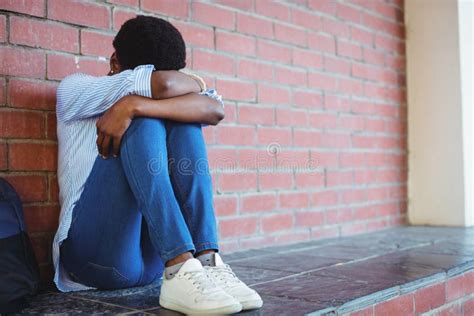 Sad Girl Sitting Against Brick Wall Stock Photos Free And Royalty Free