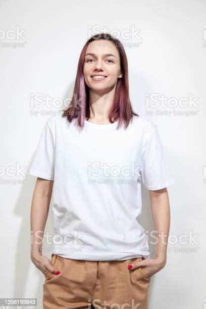 Studio Portrait Of 30 Year Old Woman With Purple Hair Stock Photo