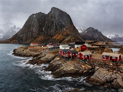 Sea And Mountains Surround The Fishing Village Of Hamnoy On Norways