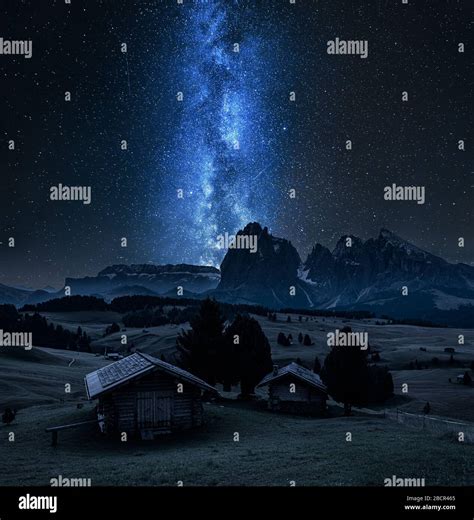 Milky Way Over Wooden Huts In Alpe Di Siusi Dolomites Stock Photo Alamy