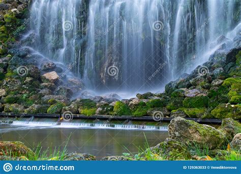 Green Moss Covered Stones In Waterfalls Stock Image