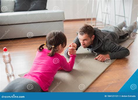 Father And Daughter Are Training At Home Workout In The Apartment