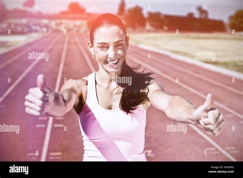 Portrait Of Female Athlete Showing Thumbs Up On Running Track Stock Photo Alamy