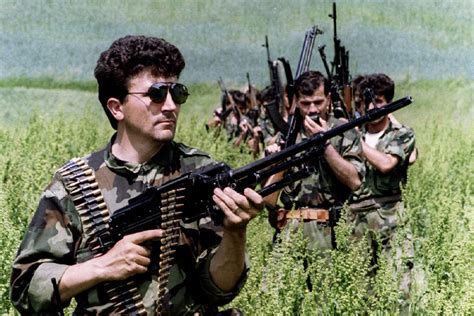Bosnian Serb Soldiers Patrol Through A Field Near The Town Of