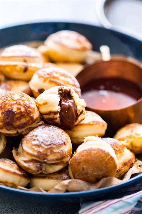Mini pancakes with Nutella filling, served with maple syrup, finger ...