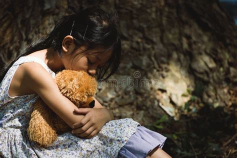 Adorable Sad Girl With Teddy Bear In Park Little Girl Is Hugging A