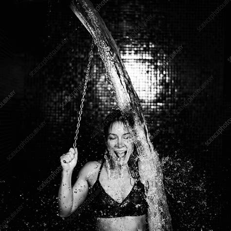 woman taking a cold shower from ice bucket stock image f027 7269 science photo library
