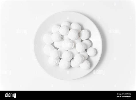 White Sugar Balls In A White Saucer On A White Background Close Up Top