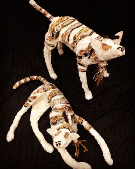 Two Cats Made Out Of Cloths On A Black Background