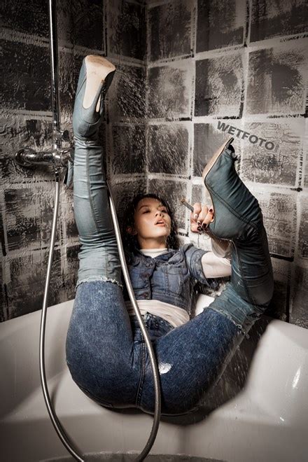 Girl In Over The Knee Denim Boots And High Waisted Skinny Jeans Gets Wet In The Bath Wetfoto Com